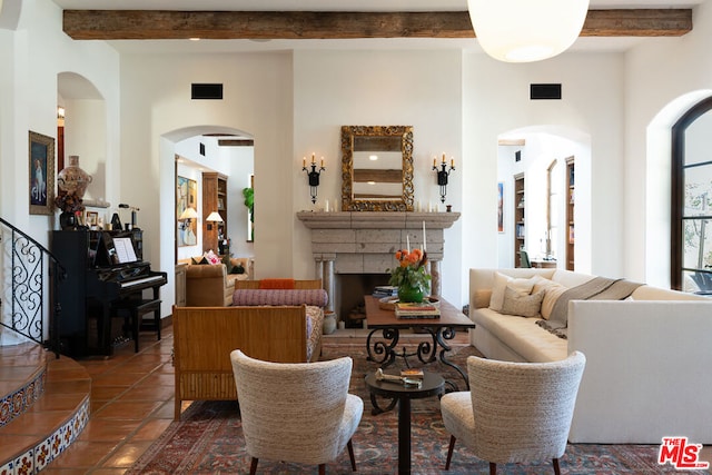 tiled living room with a towering ceiling and beam ceiling