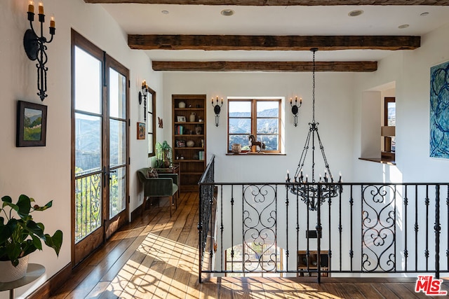 hall with hardwood / wood-style flooring and beamed ceiling