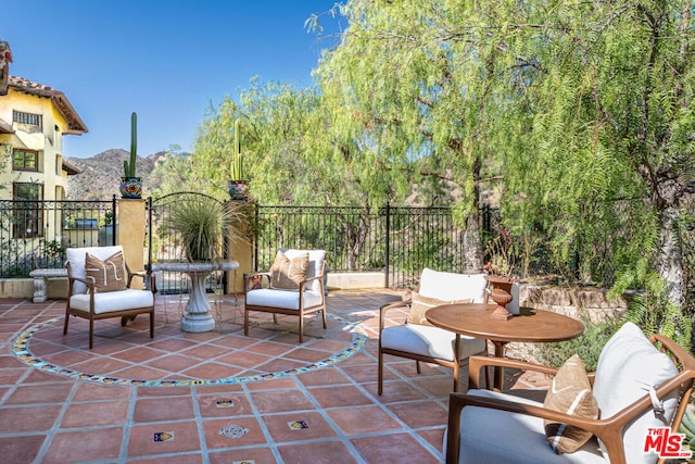 view of patio / terrace featuring a mountain view