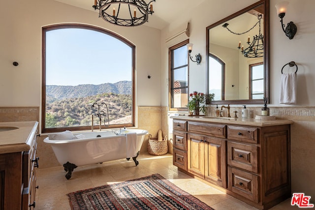 bathroom featuring vanity, a mountain view, and tile walls