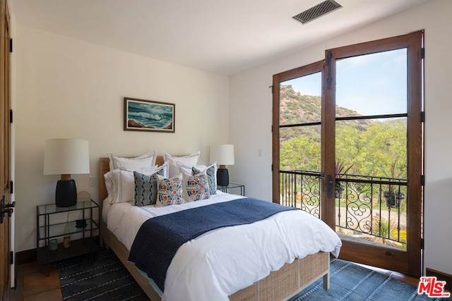 bedroom featuring access to outside and french doors