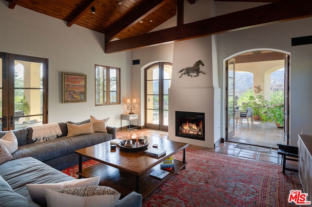 living room featuring wood ceiling, a large fireplace, and plenty of natural light