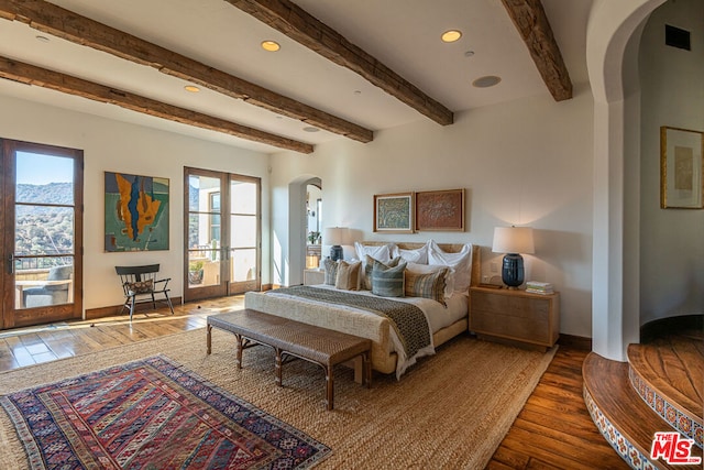 bedroom with beam ceiling, dark wood-type flooring, and french doors