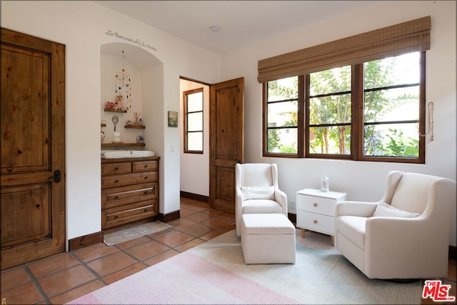 sitting room with a healthy amount of sunlight and tile patterned floors