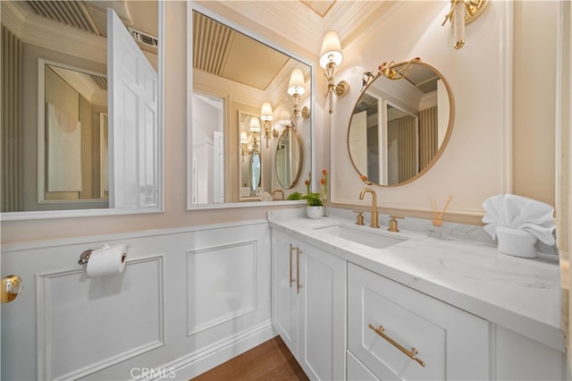 bathroom with vanity, wood-type flooring, and ornamental molding