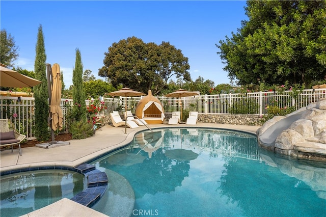 view of pool featuring an in ground hot tub and a patio area