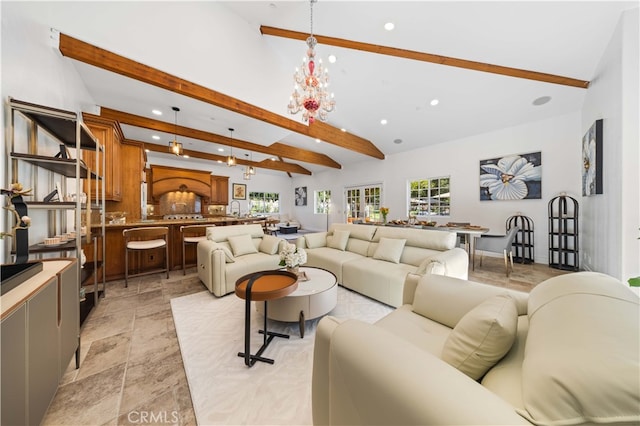 living room featuring lofted ceiling with beams and a notable chandelier