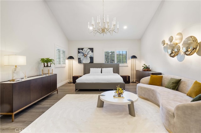 bedroom featuring hardwood / wood-style floors, an inviting chandelier, and high vaulted ceiling