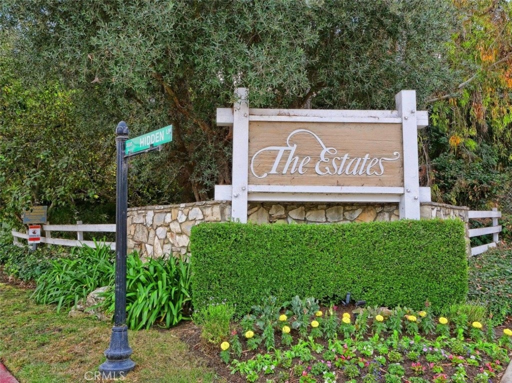 community sign featuring fence