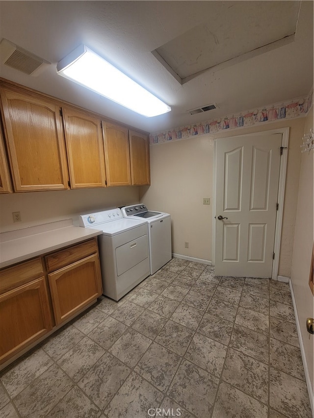 washroom featuring cabinets and washer and dryer