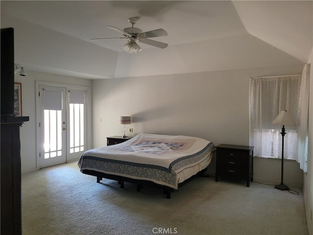 carpeted bedroom featuring vaulted ceiling, access to outside, and ceiling fan