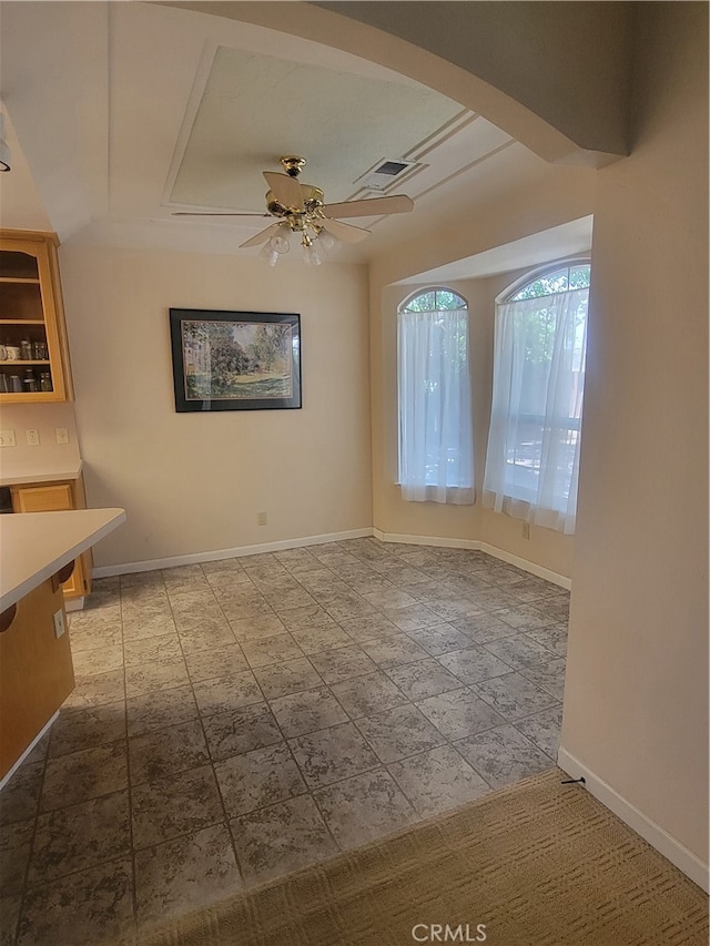 unfurnished dining area featuring ceiling fan