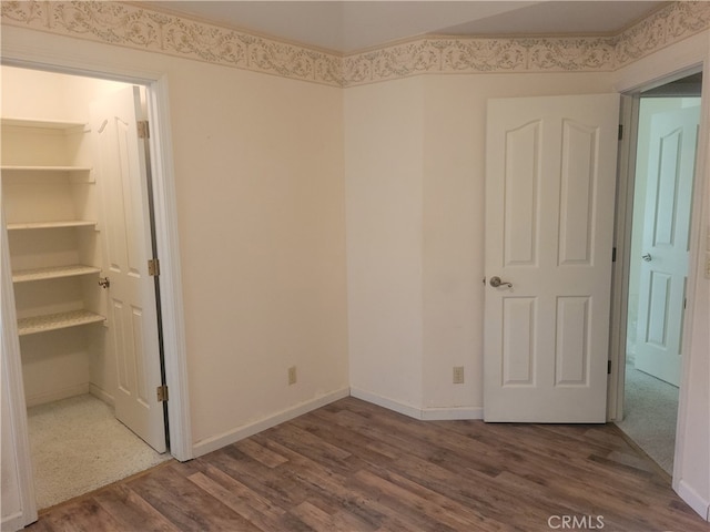 unfurnished bedroom with hardwood / wood-style flooring