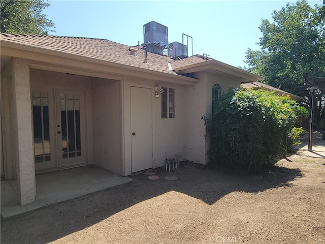 rear view of property with central AC and a patio