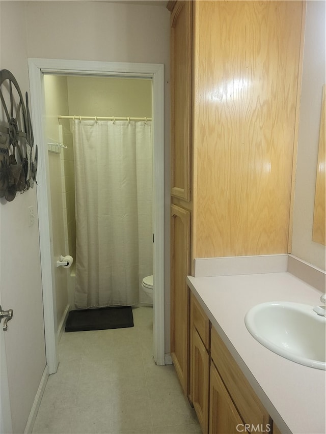 bathroom with vanity, toilet, tile patterned floors, and a shower with shower curtain