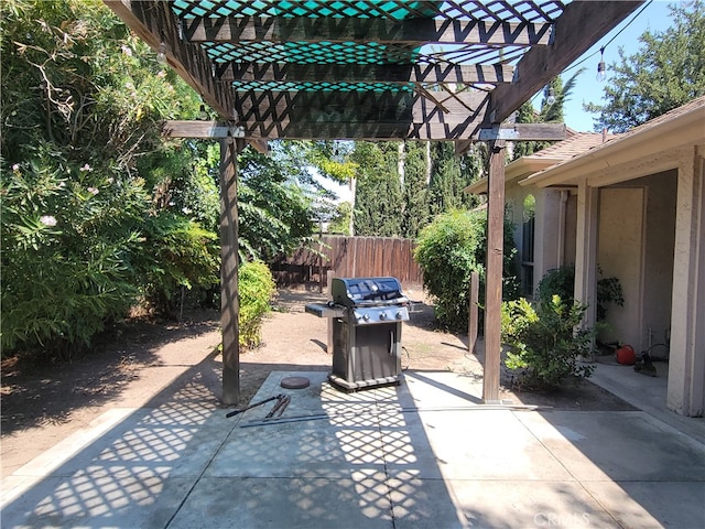 view of patio with grilling area and a pergola