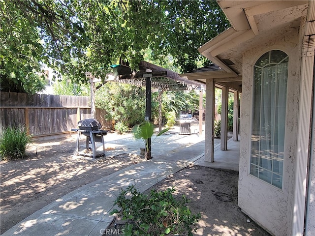 view of patio / terrace with a grill and a pergola