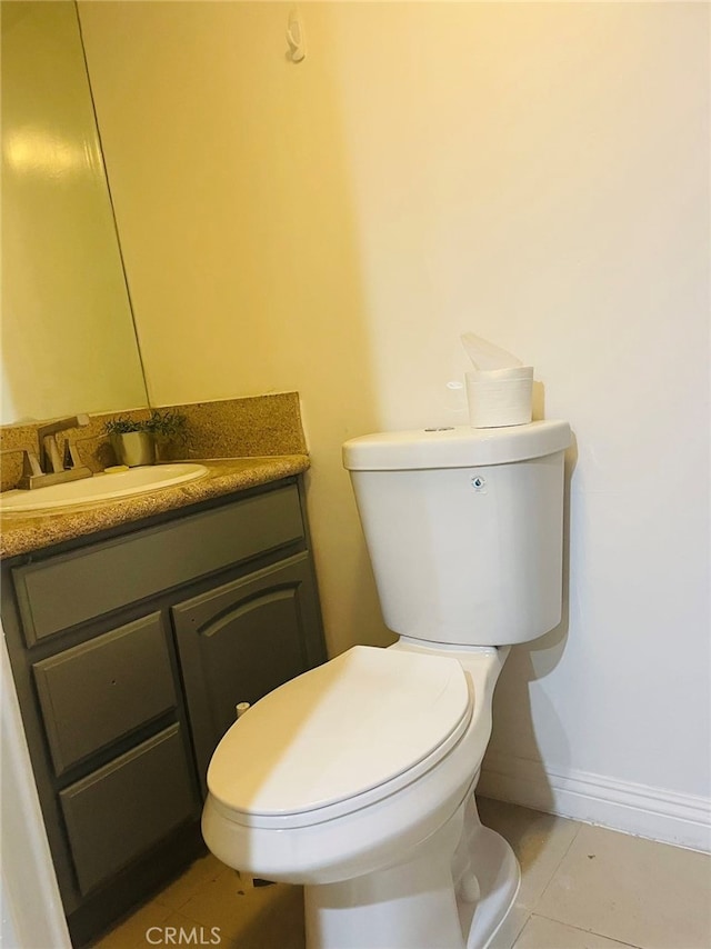 bathroom featuring vanity, toilet, and tile patterned floors