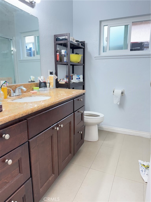 bathroom with vanity, an enclosed shower, toilet, and tile patterned flooring