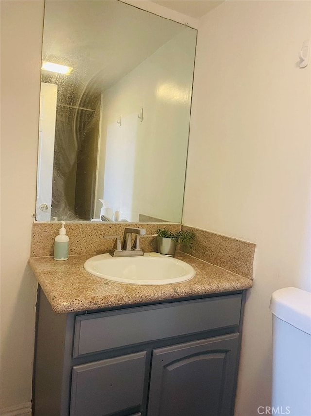 bathroom with vanity and toilet