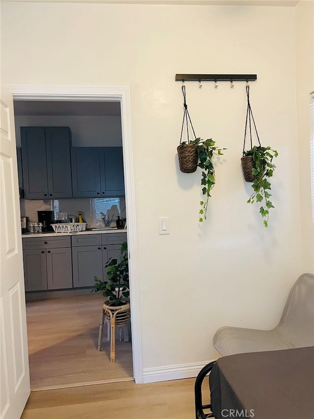 interior space featuring gray cabinetry and light hardwood / wood-style floors