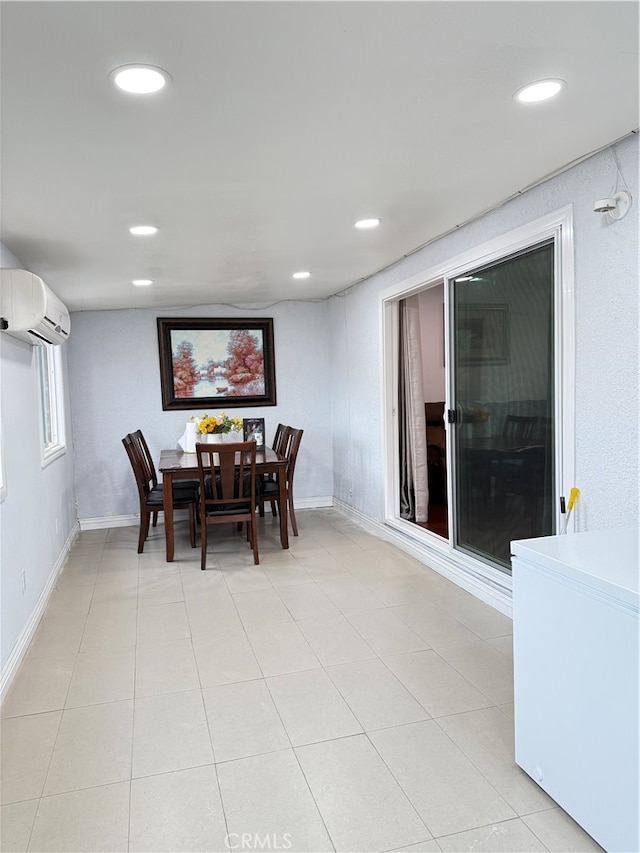 tiled dining room featuring a wall mounted AC