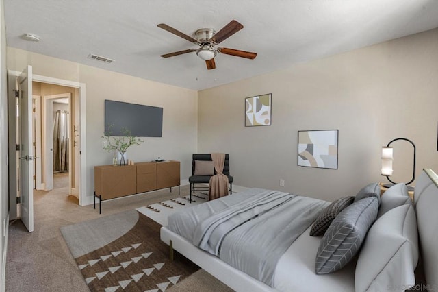 bedroom featuring ceiling fan and light carpet