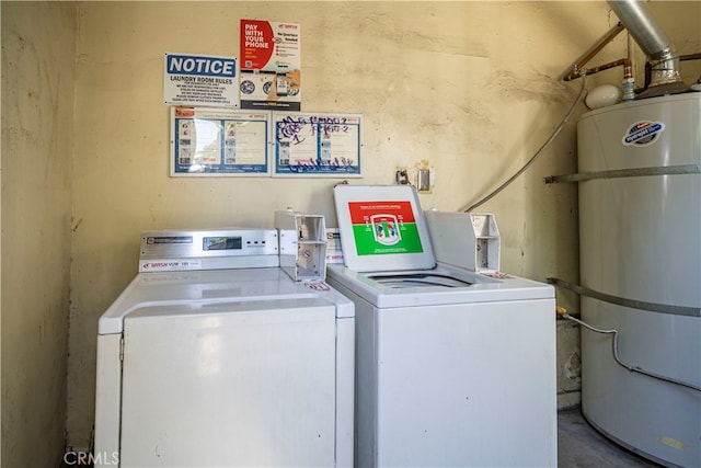 washroom with washer and dryer and secured water heater