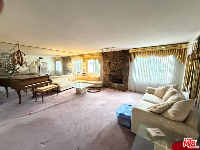 living room with a stone fireplace and carpet