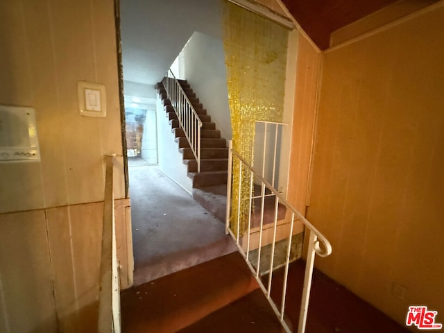 stairway featuring concrete floors