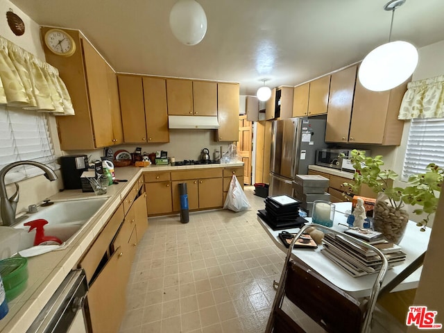 kitchen featuring pendant lighting, sink, and appliances with stainless steel finishes