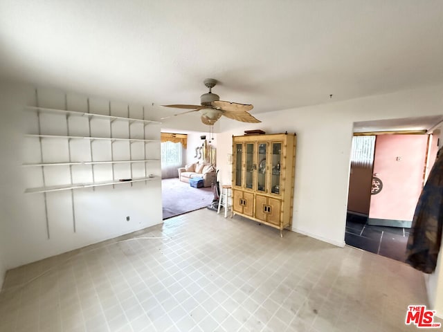 unfurnished living room with ceiling fan