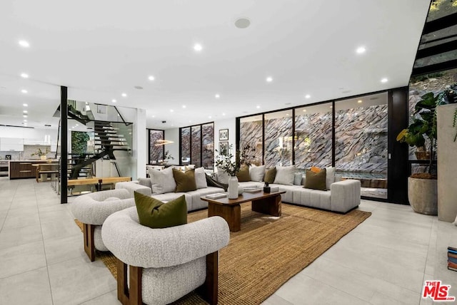 tiled living room featuring floor to ceiling windows