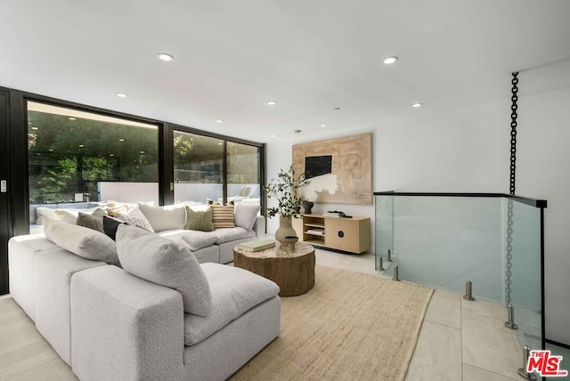 living room featuring expansive windows and light tile patterned floors