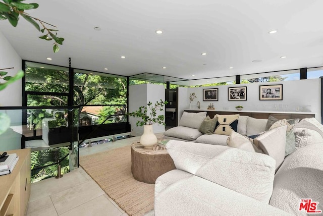 tiled living room with floor to ceiling windows