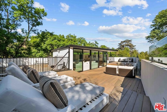 wooden terrace featuring outdoor lounge area