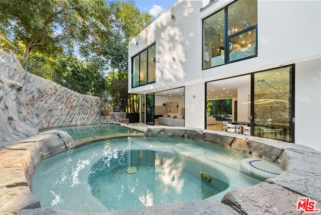 view of pool with an in ground hot tub