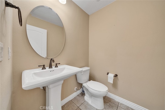 bathroom featuring toilet and tile patterned flooring