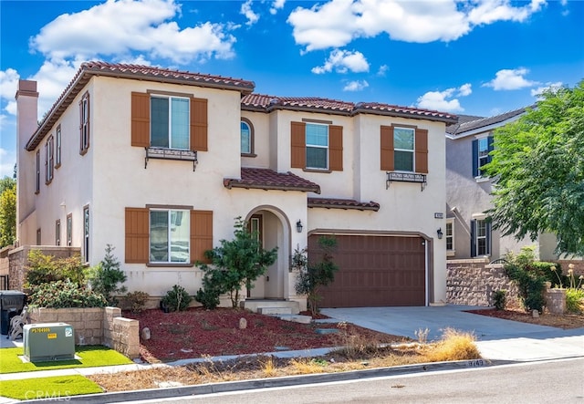 mediterranean / spanish-style home featuring a garage