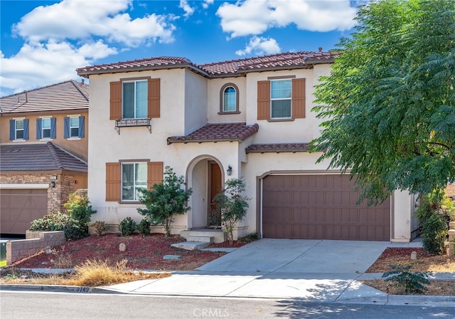 mediterranean / spanish-style home with a garage