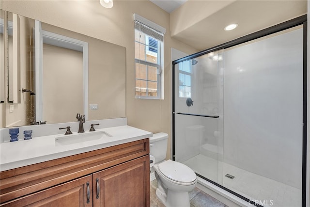 bathroom featuring a shower with door, vanity, toilet, and tile patterned flooring