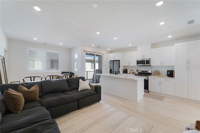 living room with light hardwood / wood-style flooring