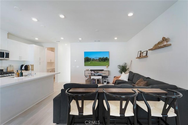 interior space featuring sink and light hardwood / wood-style floors