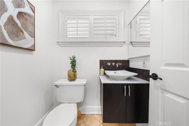 bathroom featuring tile patterned flooring, vanity, and toilet