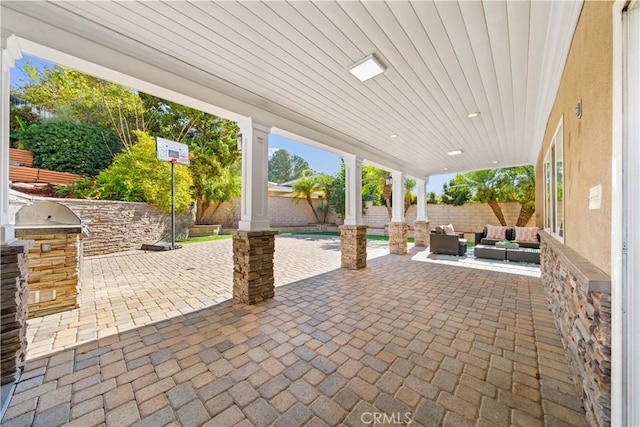 view of patio featuring an outdoor living space and an outdoor kitchen