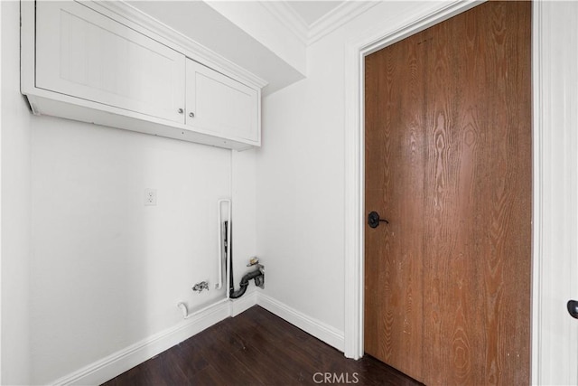 washroom with cabinets, crown molding, dark wood-type flooring, and gas dryer hookup