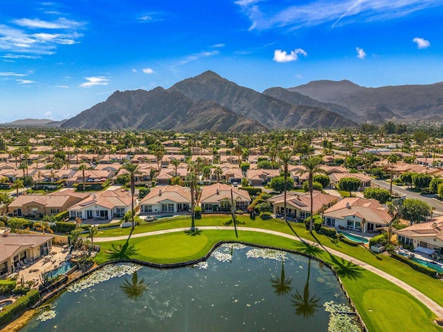 drone / aerial view with a water and mountain view