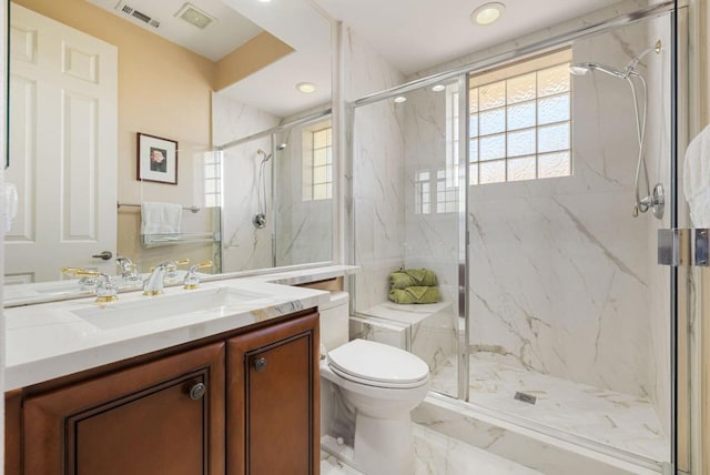 bathroom featuring vanity, toilet, and an enclosed shower