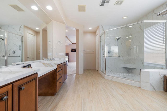 bathroom featuring hardwood / wood-style flooring, vanity, and a shower with shower door