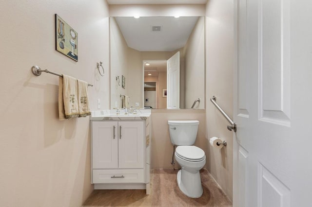 bathroom with vanity and toilet